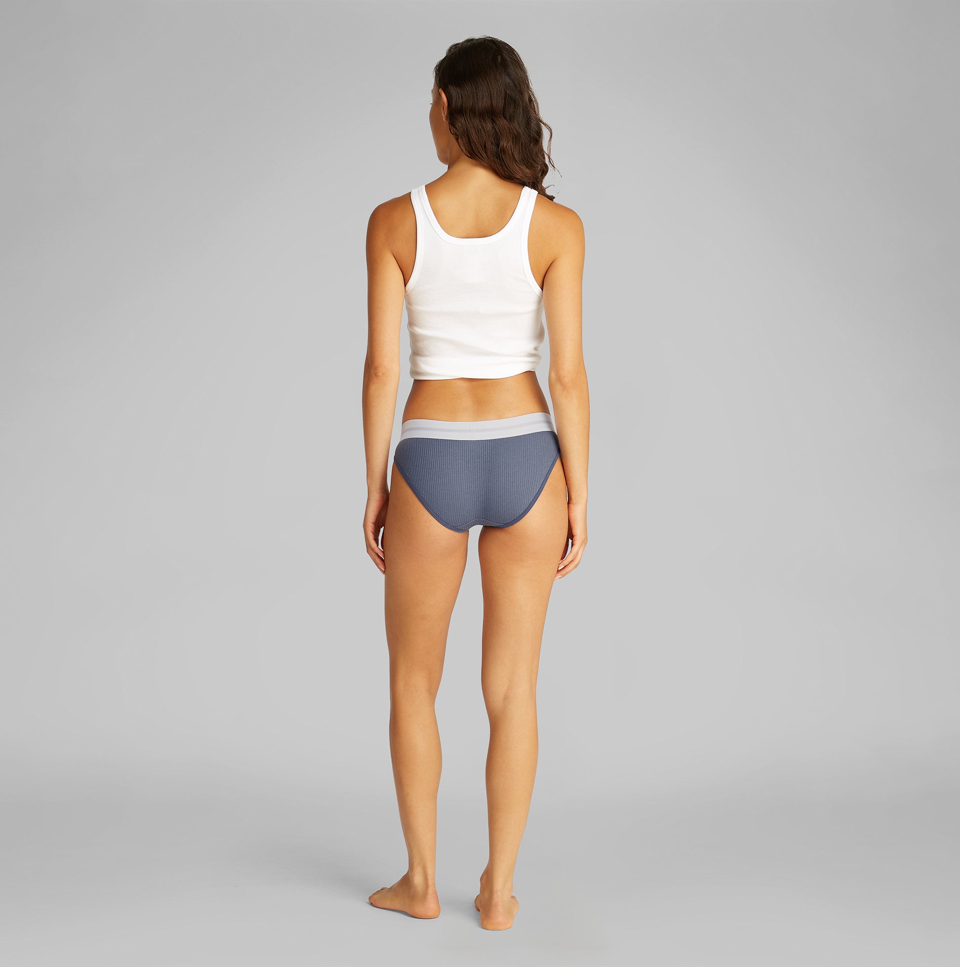 Calvin Klein BIKINI Brief Womens Cotton Modal Stretch Rib Grisaille back view on model wearing white tank top.