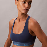 Calvin Klein Icon Cotton Modal Womens Unlined Bralette Denim side view model wearing navy bralette showcasing design and fit.