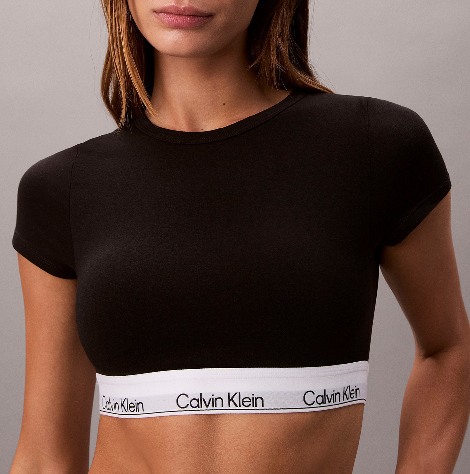 Calvin Klein T-SHIRT BRALETTE Womens Black front view featuring logo band and fitted design