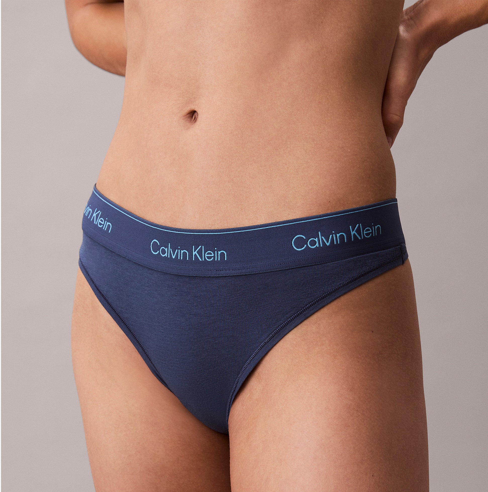 Calvin Klein Icon Cotton Modal Womens Thong Denim side view featuring navy blue color and signature logo waistband.