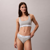 Calvin Klein Icon Cotton Modal Womens Thong Grey worn by model, side view, showcasing details of the thong and bra.