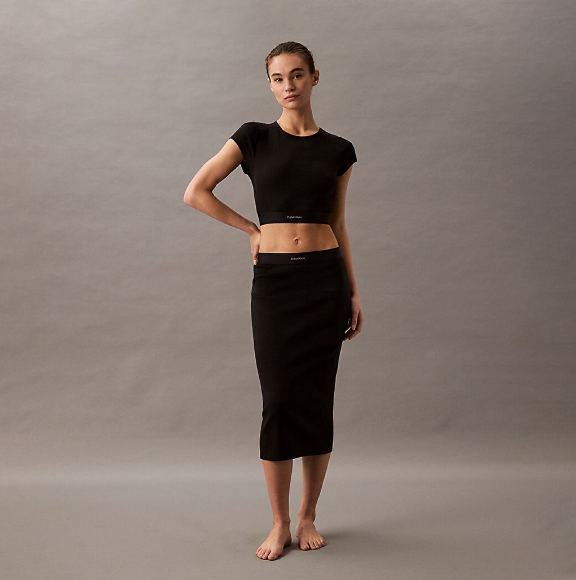 Calvin Klein COTTON STRETCH RIB Womens Crop Top Black front view on model, paired with matching black skirt.
