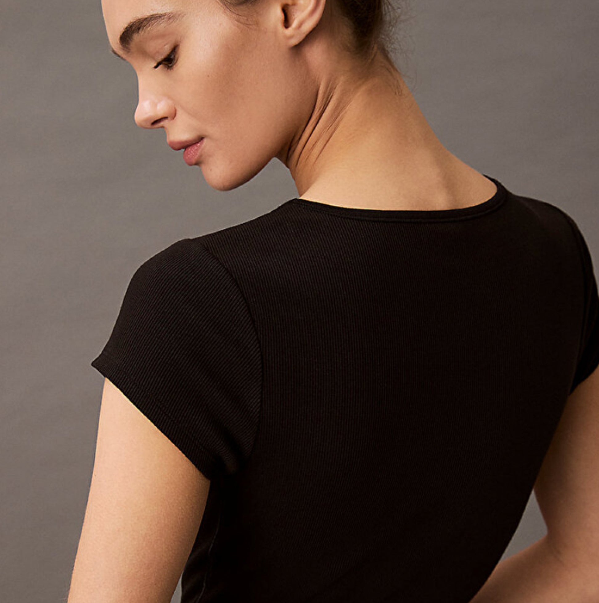 Calvin Klein COTTON STRETCH RIB Womens Crop Top Black back view showcasing short sleeves and fine ribbed texture.