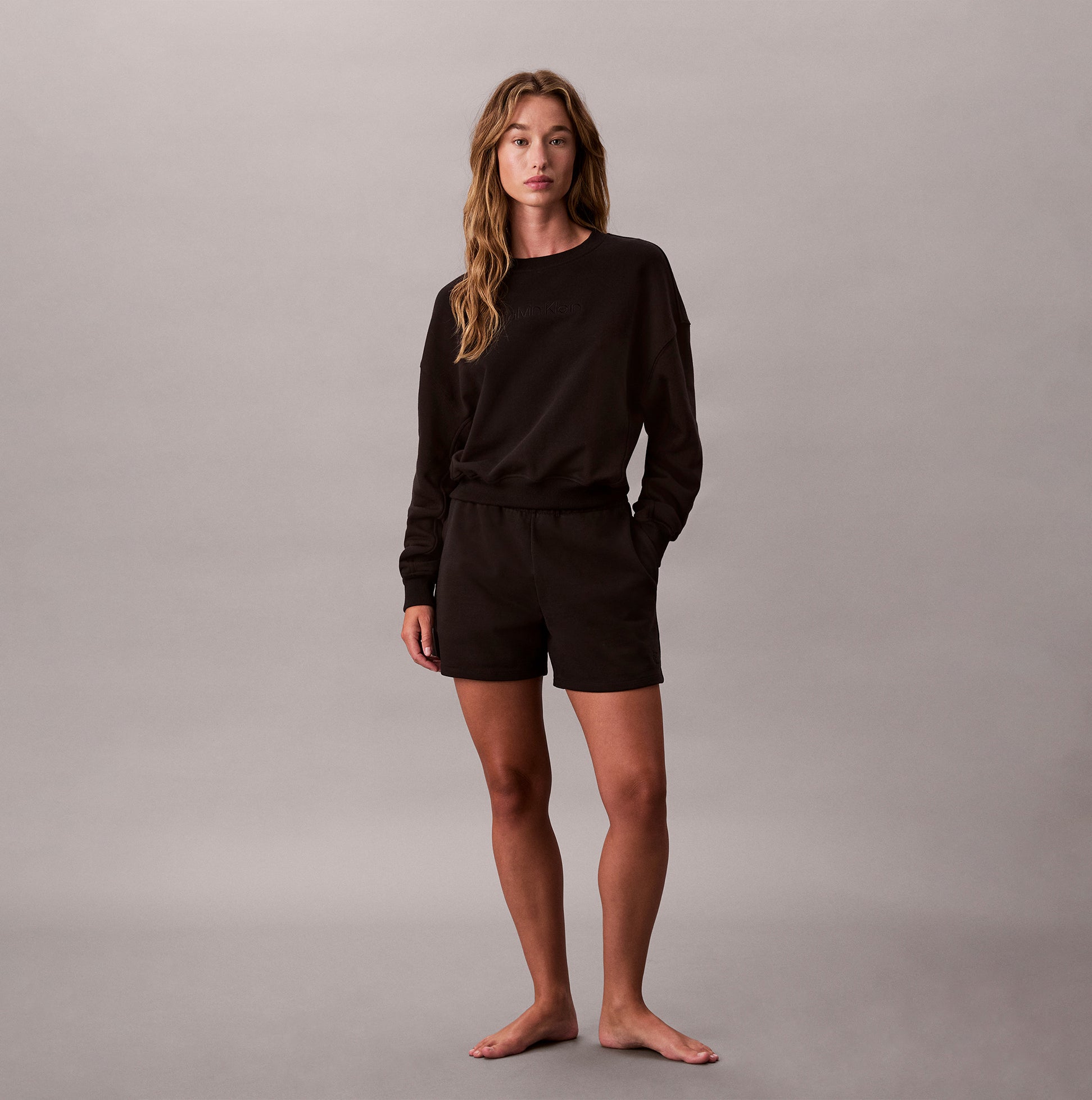 Calvin Klein Womens Long Sleeve Pyjama Top Black front view on model with black shorts, stylish and comfortable sleepwear.