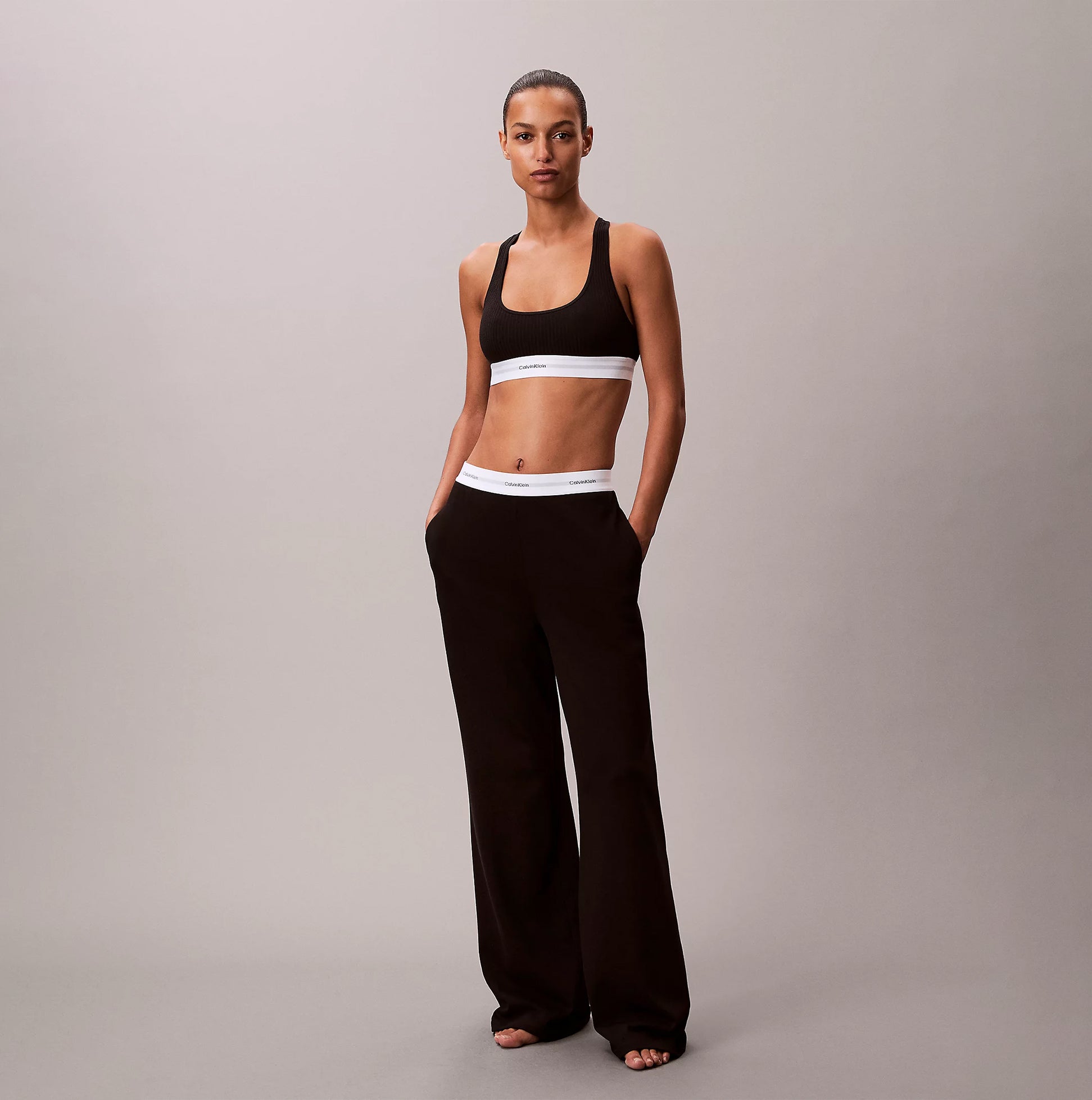 Calvin Klein LOGO JERSEY PANT Womens Black front view worn with matching cropped sports bra.