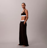 Calvin Klein LOGO JERSEY PANT Womens Black side view, showcasing relaxed fit and pockets.