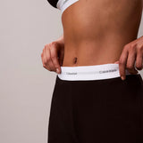 Calvin Klein LOGO JERSEY PANT Womens Black side view showcasing waistband logo detail.