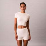 Calvin Klein SEAMLESS TEE Womens Printed CK Knit T-Shirt Ivory front view model wearing lightweight knitted top.