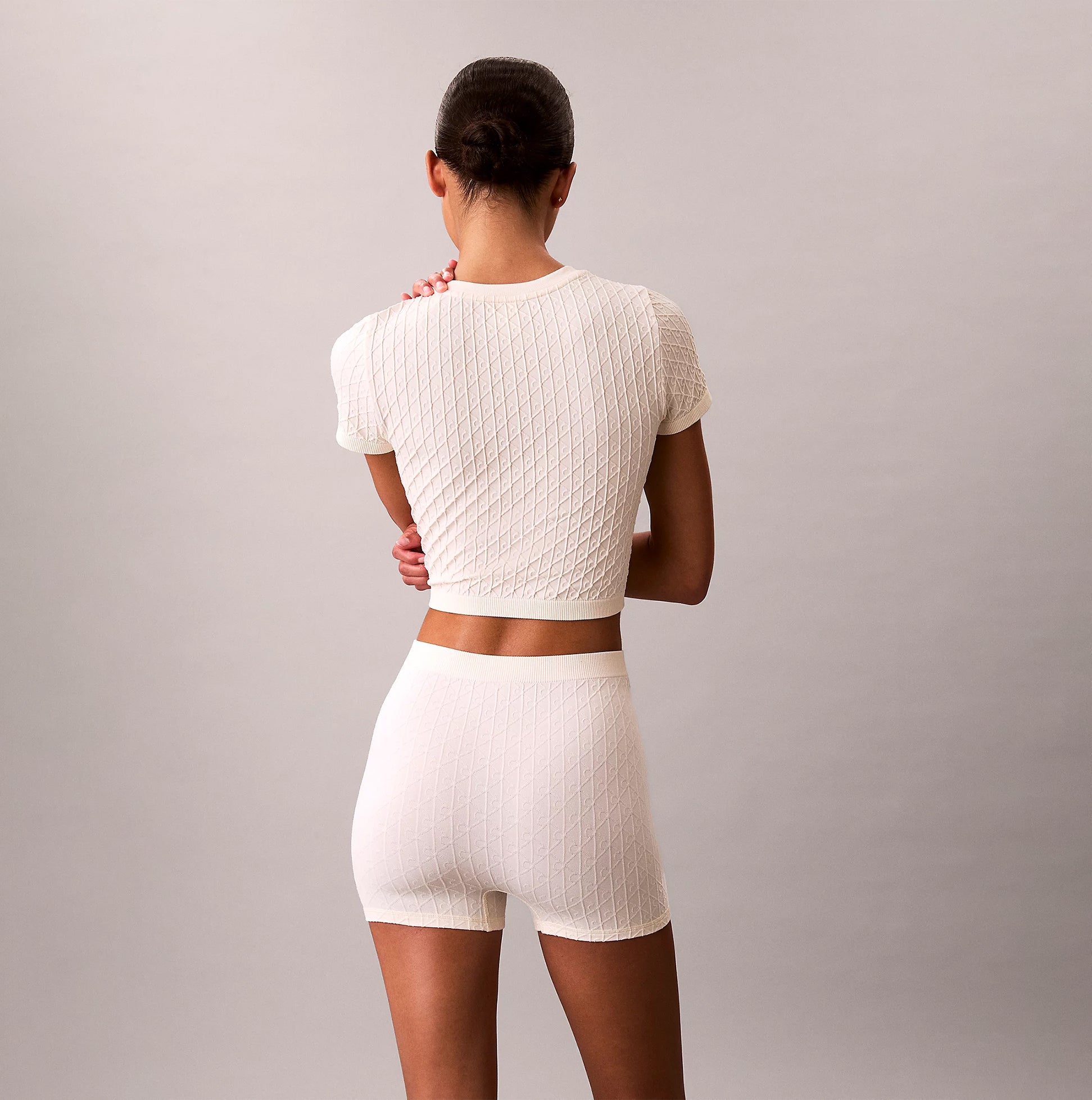 Calvin Klein SEAMLESS TEE Womens Printed CK Knit T-Shirt Ivory back view showing knit texture and fit.