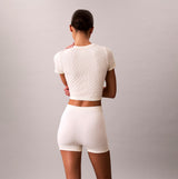 Calvin Klein SEAMLESS TEE Womens Printed CK Knit T-Shirt Ivory back view showing knit texture and fit.