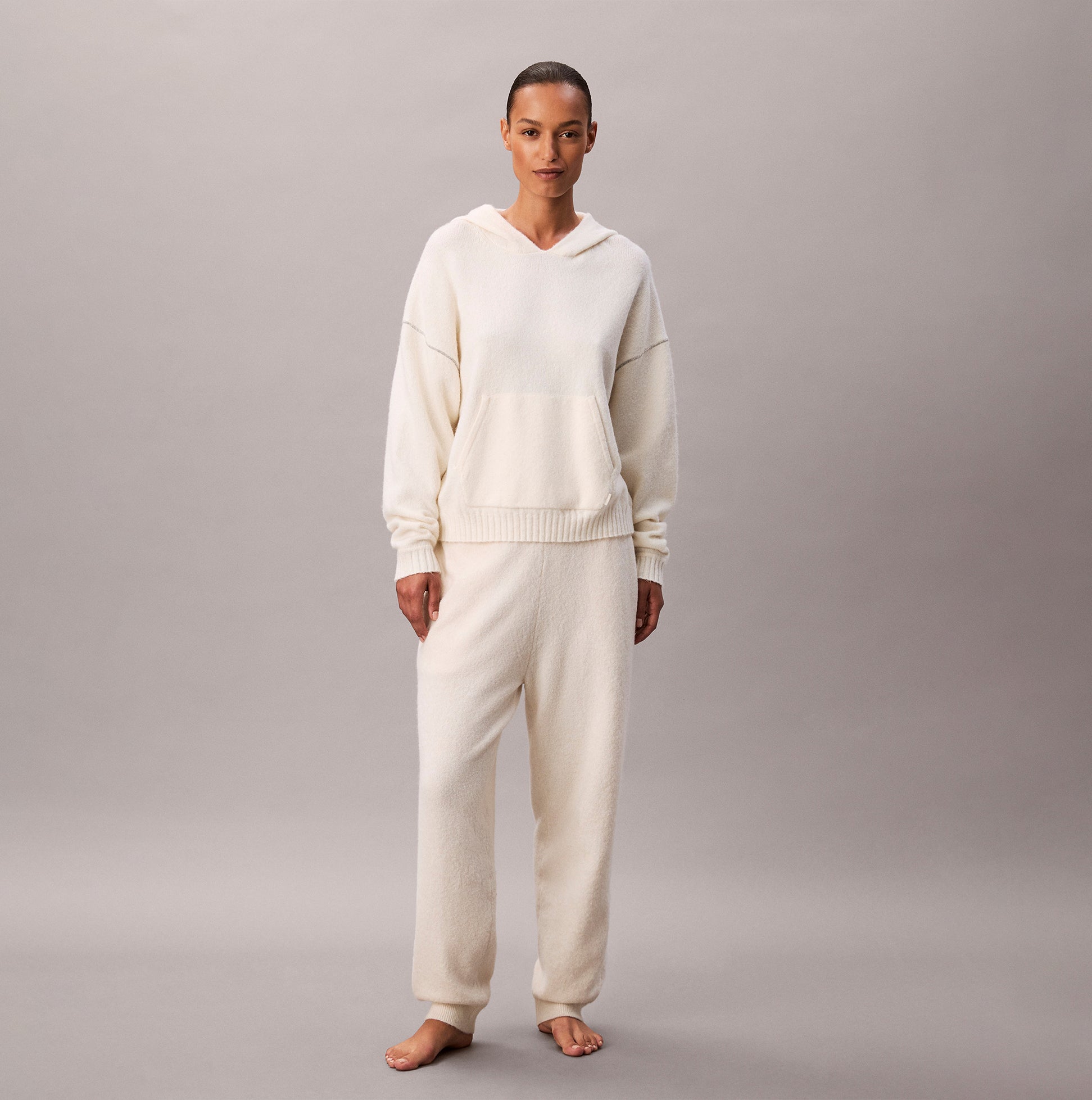 Calvin Klein PLUSH HOODIE. Womens Ivory front view worn by model, showcasing soft fabric and relaxed fit.