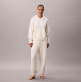 Calvin Klein PLUSH HOODIE. Womens Ivory front view worn by model, showcasing soft fabric and relaxed fit.