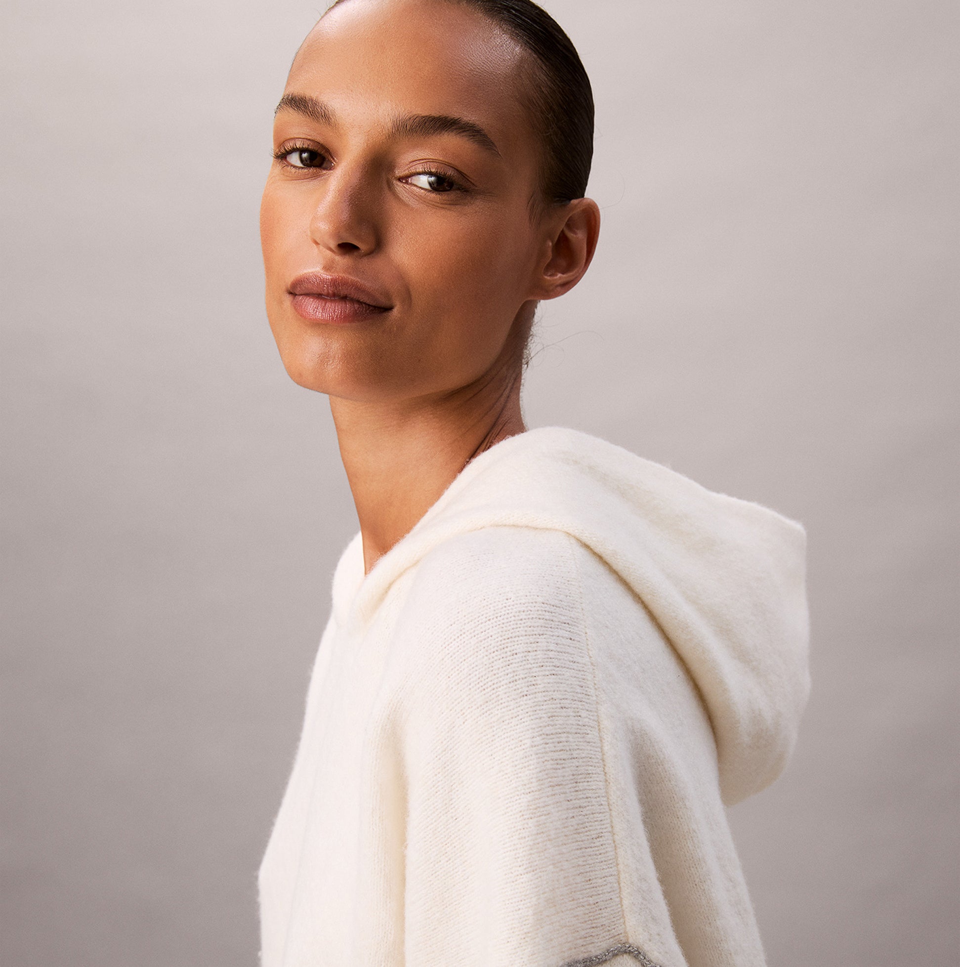 Calvin Klein PLUSH HOODIE. Womens Ivory. Side view of a model wearing the plush hoodie with a soft texture.