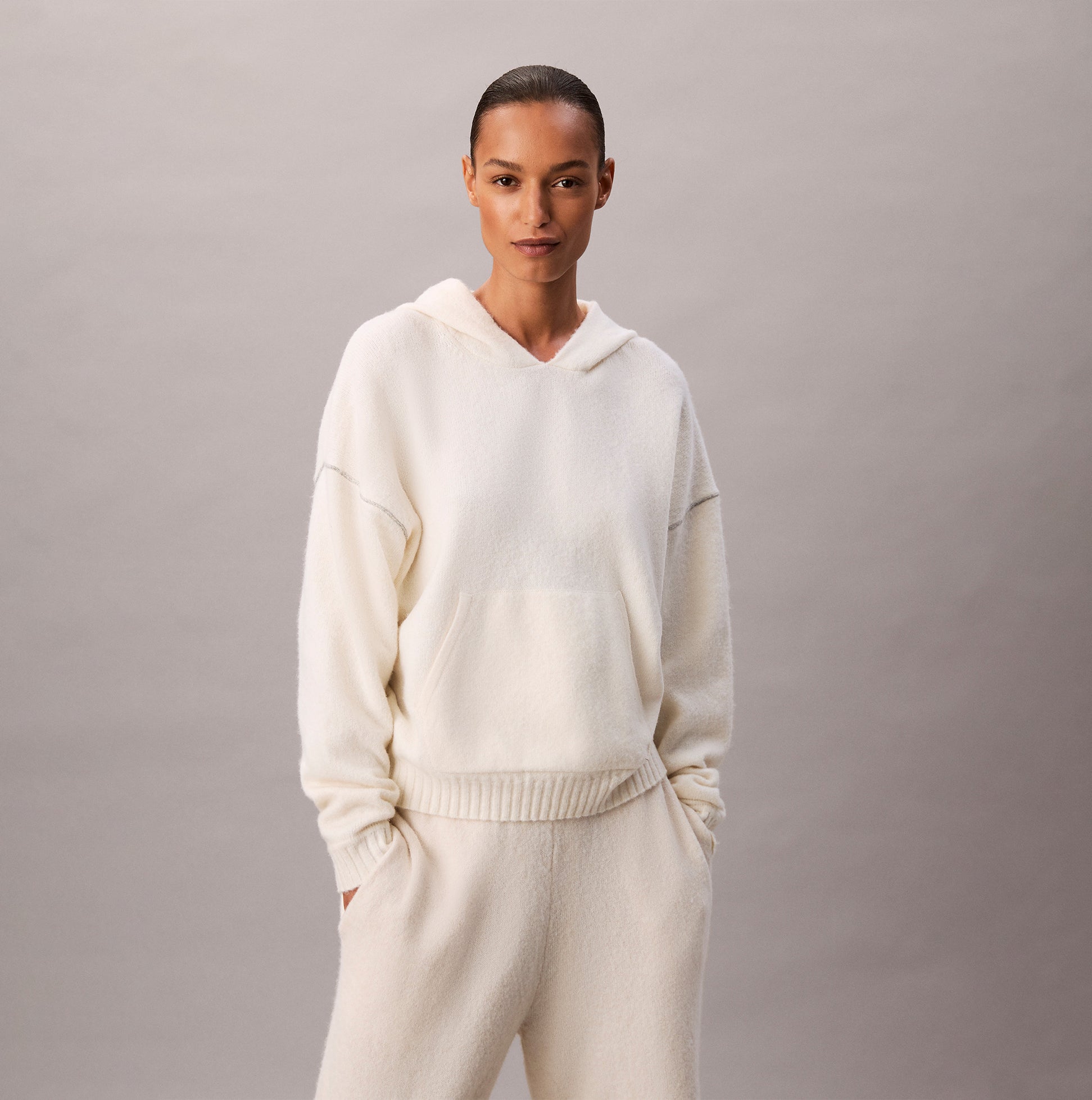 Calvin Klein PLUSH HOODIE. Womens Ivory, front view of the cozy hoodie with hood and pouch pocket.