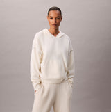 Calvin Klein PLUSH HOODIE. Womens Ivory, front view of the cozy hoodie with hood and pouch pocket.