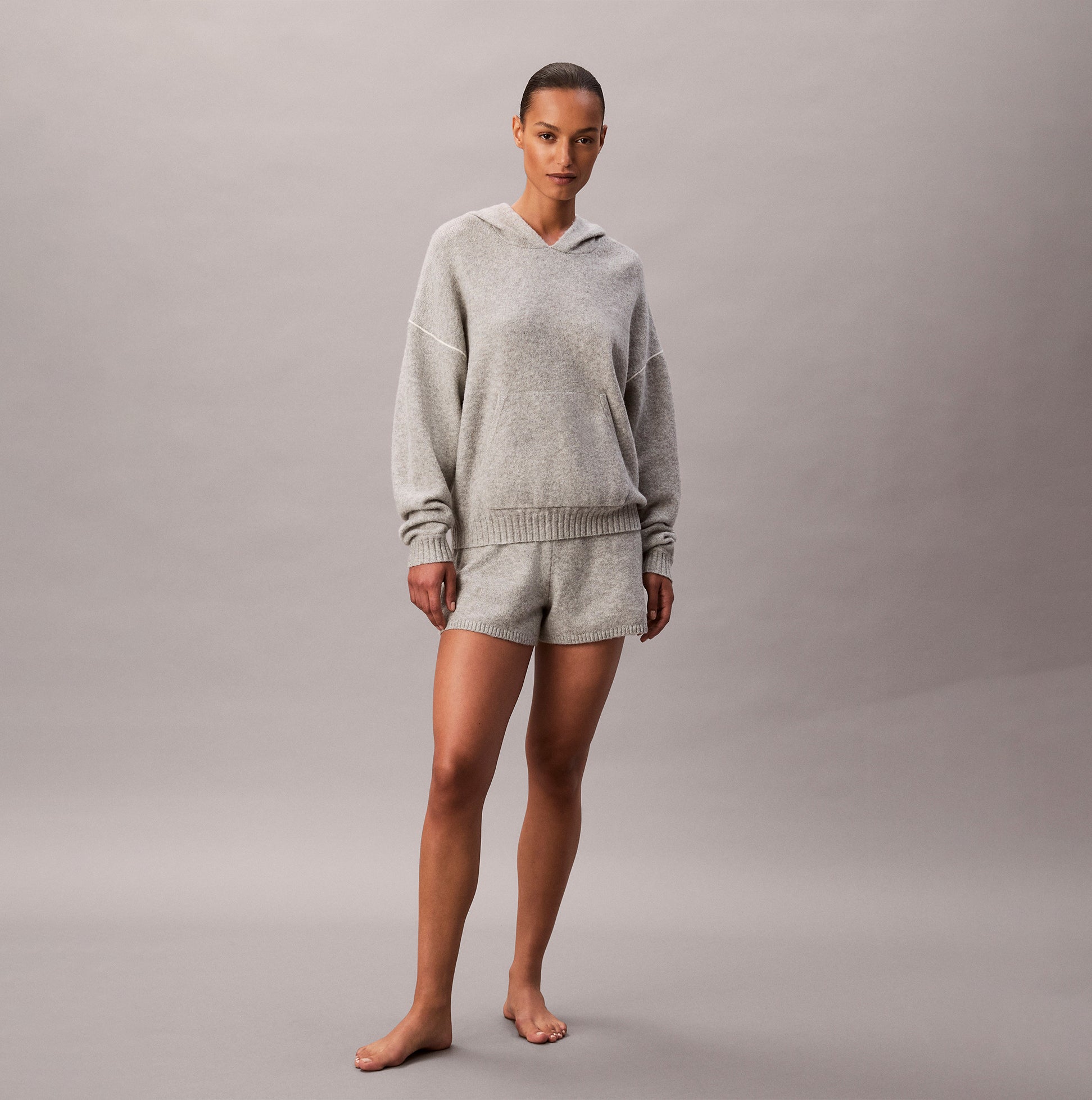 Calvin Klein PLUSH HOODIE. Womens Hoodies Grey Heather front view on model, showcasing relaxed fit and soft texture.