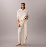 Calvin Klein PLUSH JOGGER. Womens Ivory front view showcasing relaxed fit and soft texture.