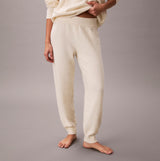 Calvin Klein PLUSH JOGGER. Womens Ivory. Side view of soft joggers in ivory color with elastic waistband.