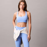 Calvin Klein Womens Quick-Dry Medium Impact Sports Bra Blue front view, styled with matching workout leggings.