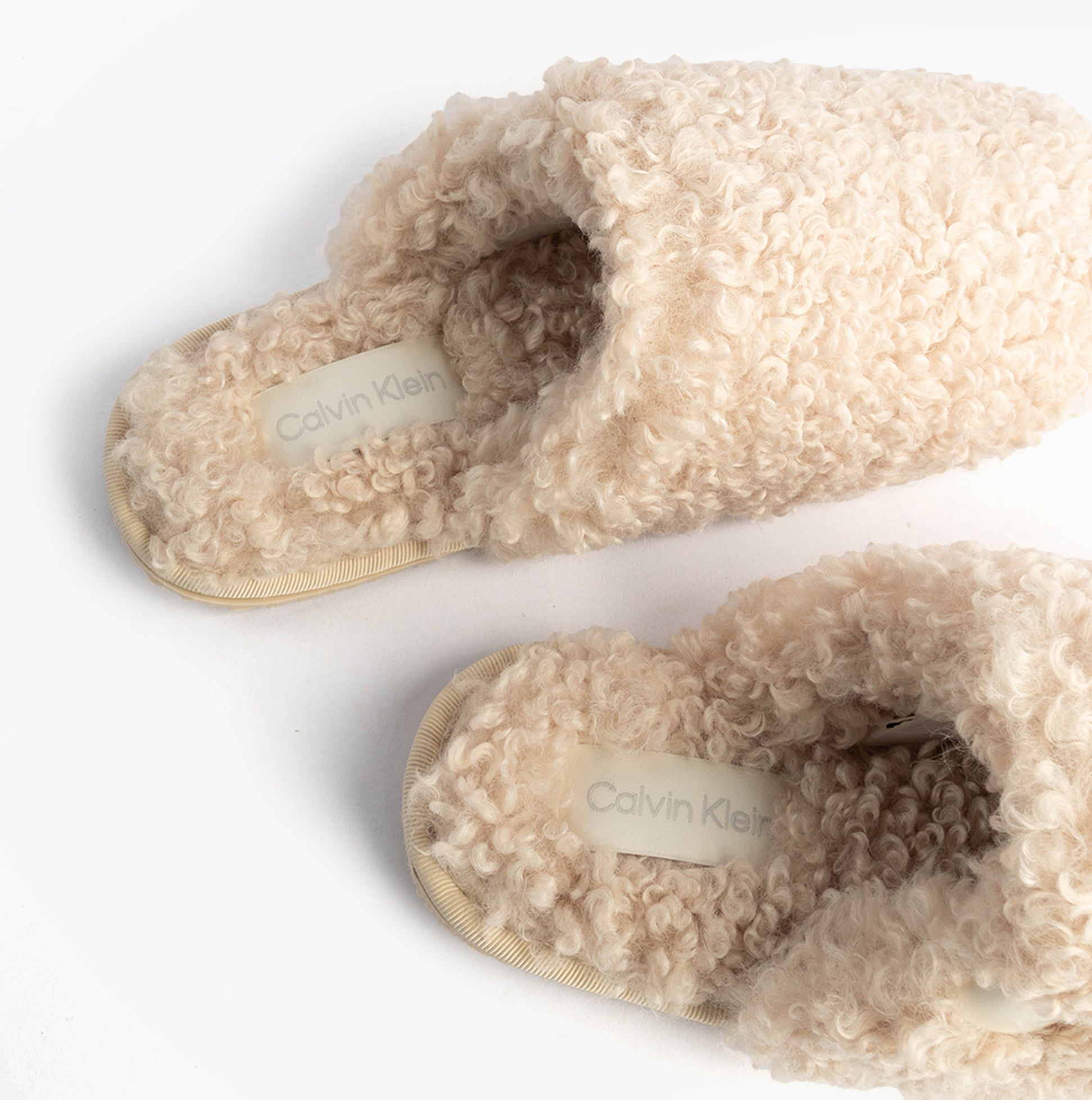 Calvin Klein CLOSE SLIPPER FUR Womens Slippers Marshmallow top view showcasing plush faux fur upper and comfortable slip-on design.
