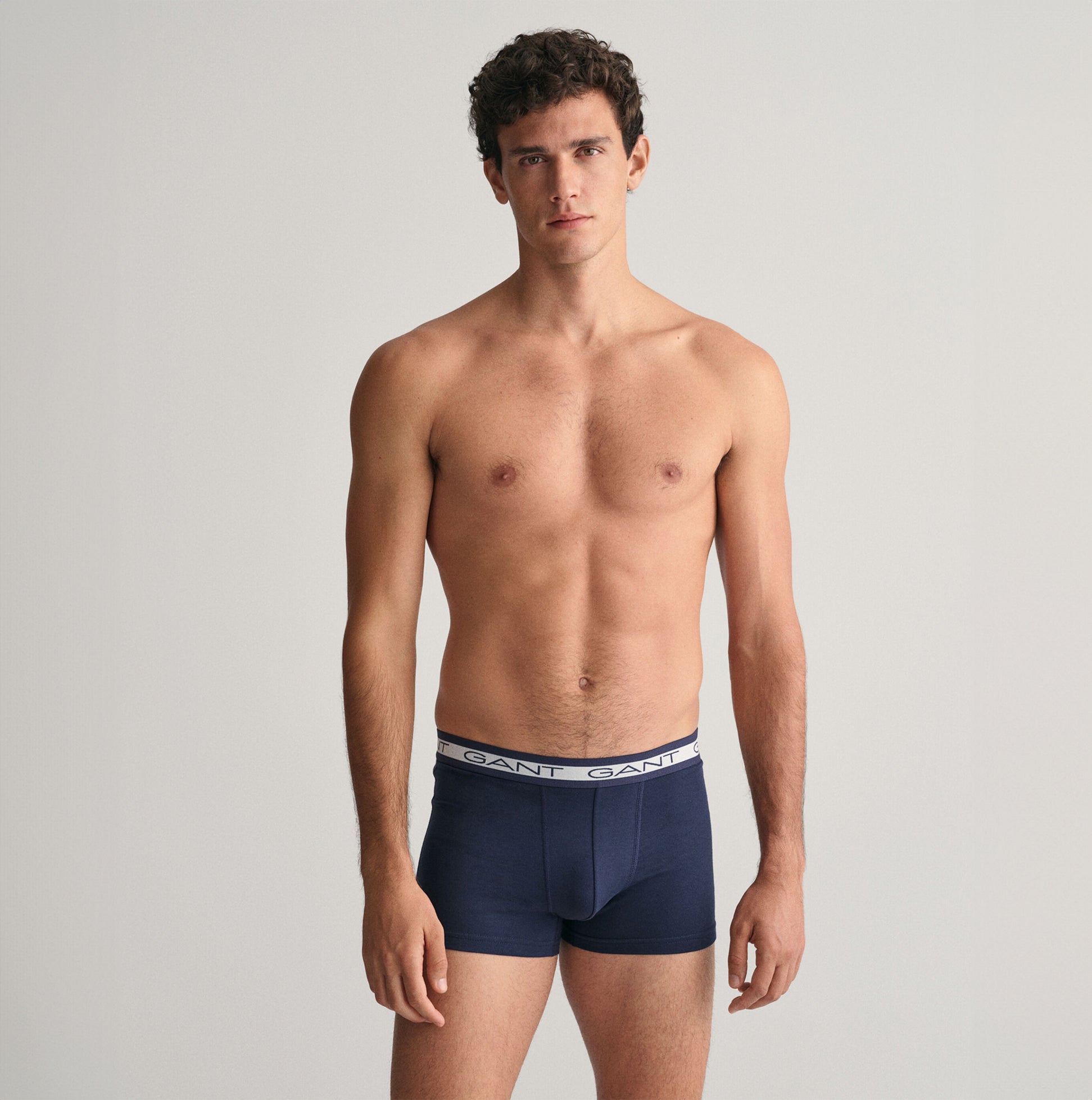 GANT CORE Mens 3 Pack Trunks Marine - Front view of model wearing navy trunks with GANT logo waistband.