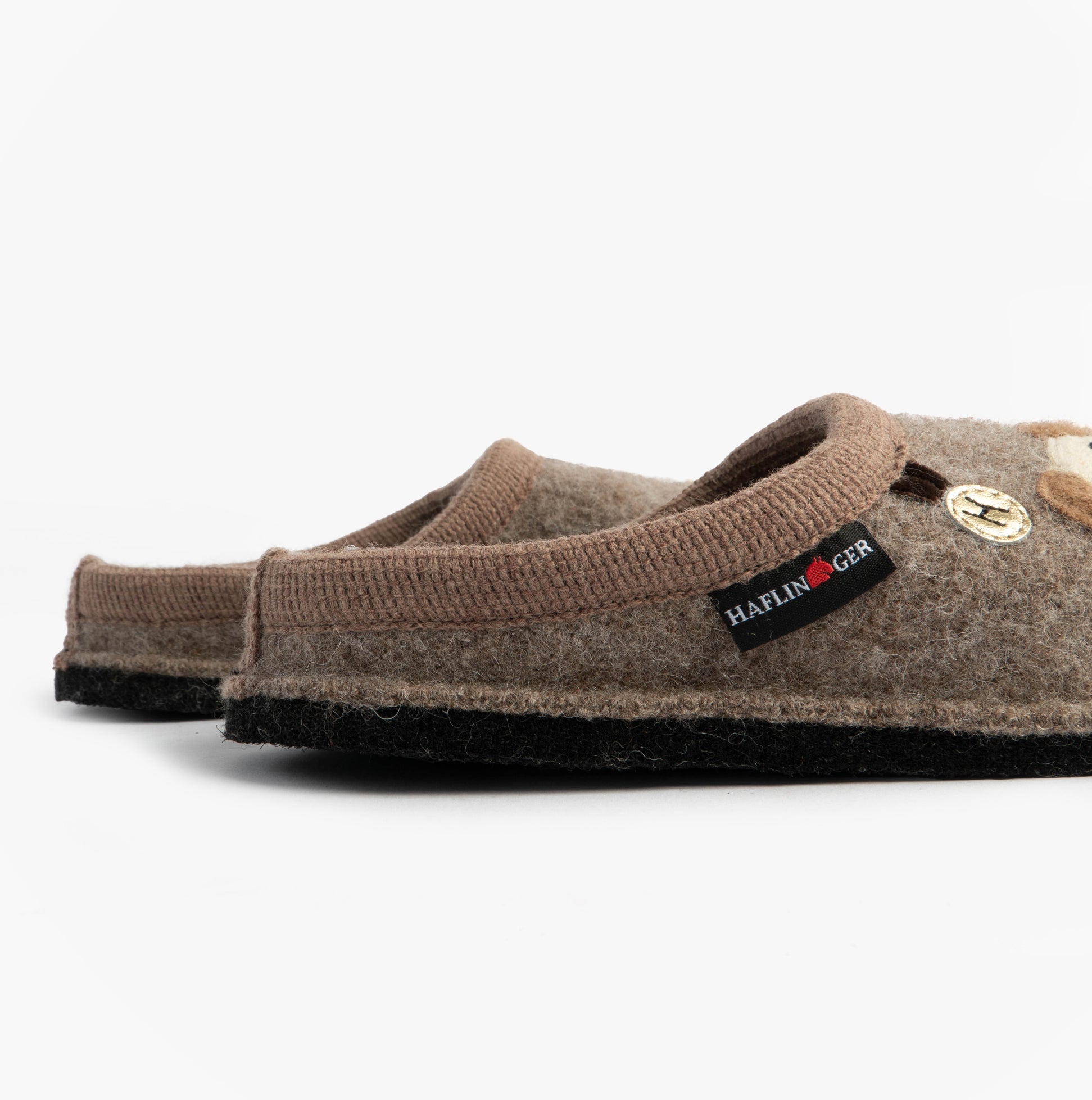 Haflinger FIDO Womens Slippers Beige side view showing textile upper and rubber sole, stylish slip-on mules.