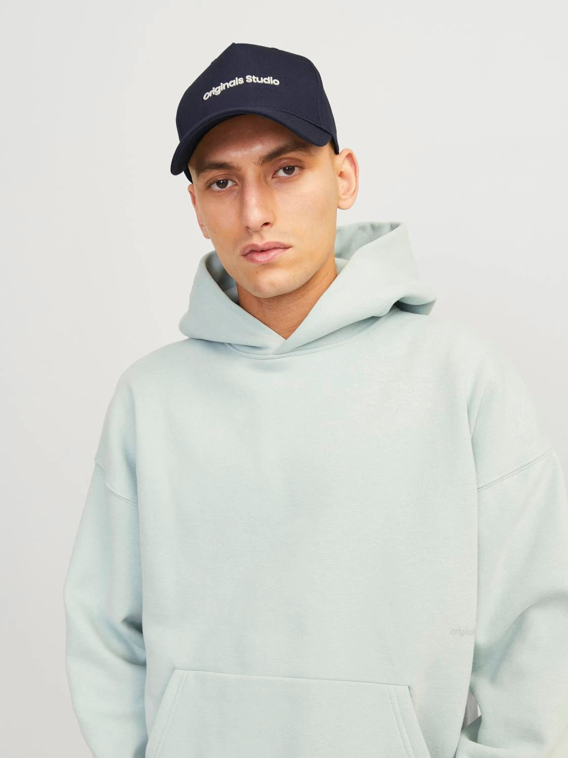 Jack & Jones VESTERBRO Mens Cap Sky Captain front view worn by model with mint green hoodie.