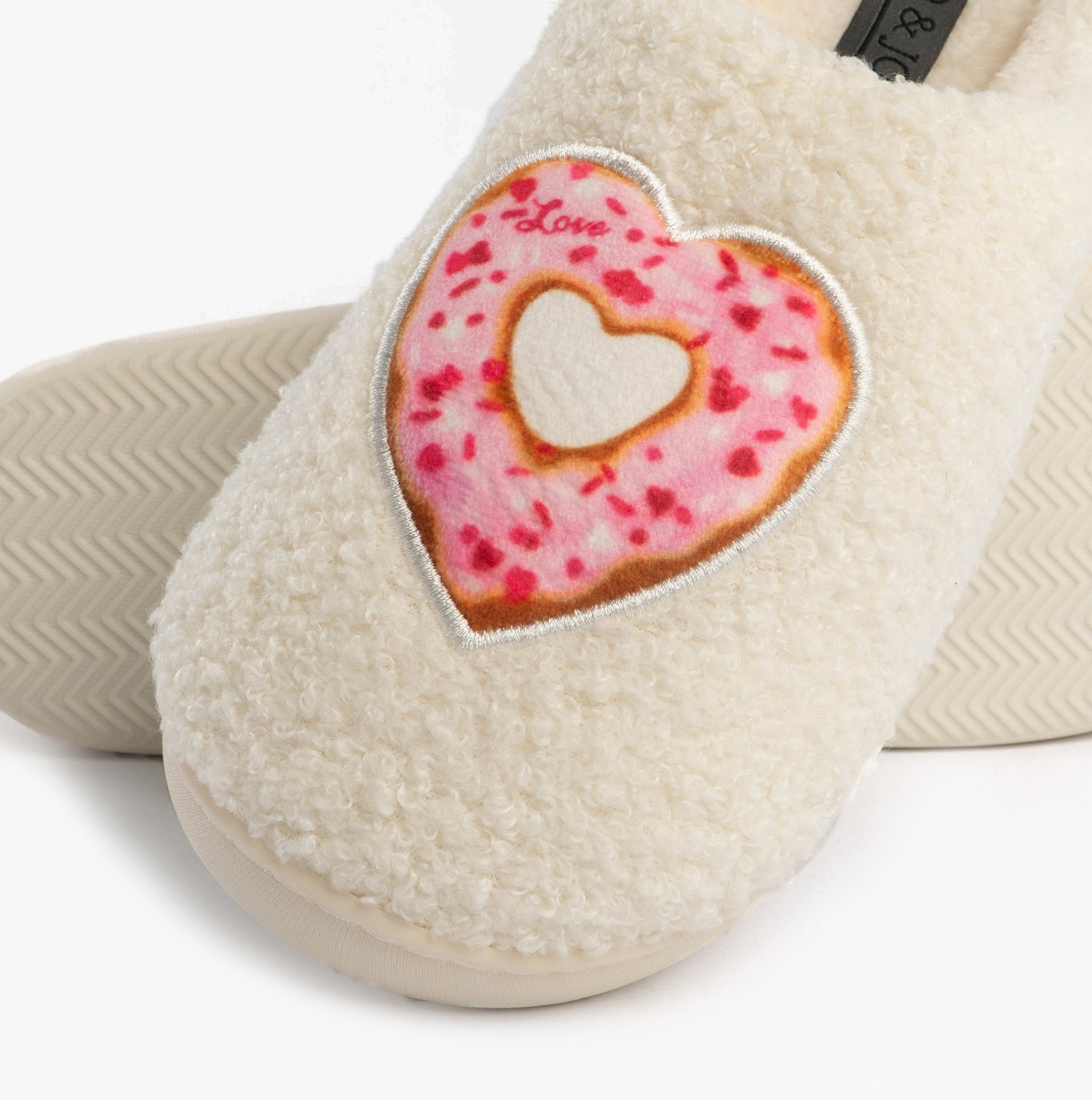 Jo & Joe DELIGHT Womens Mule Slippers Cream detail view featuring a heart-shaped donut design on a soft cream slipper.