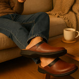 Josef Seibel MAX Mens Clogs Brandy side view on a person relaxing on a couch, showcasing the leather design and comfort.