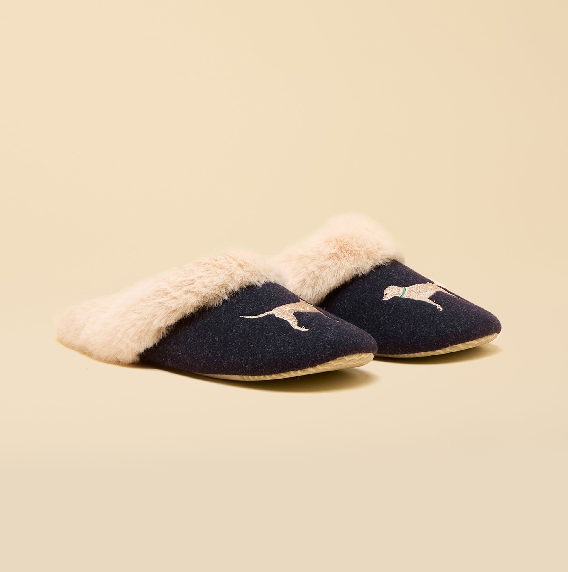 Joules SLIPPET Womens Mule Slippers Navy side view with plush lining and dog designs on a beige background.