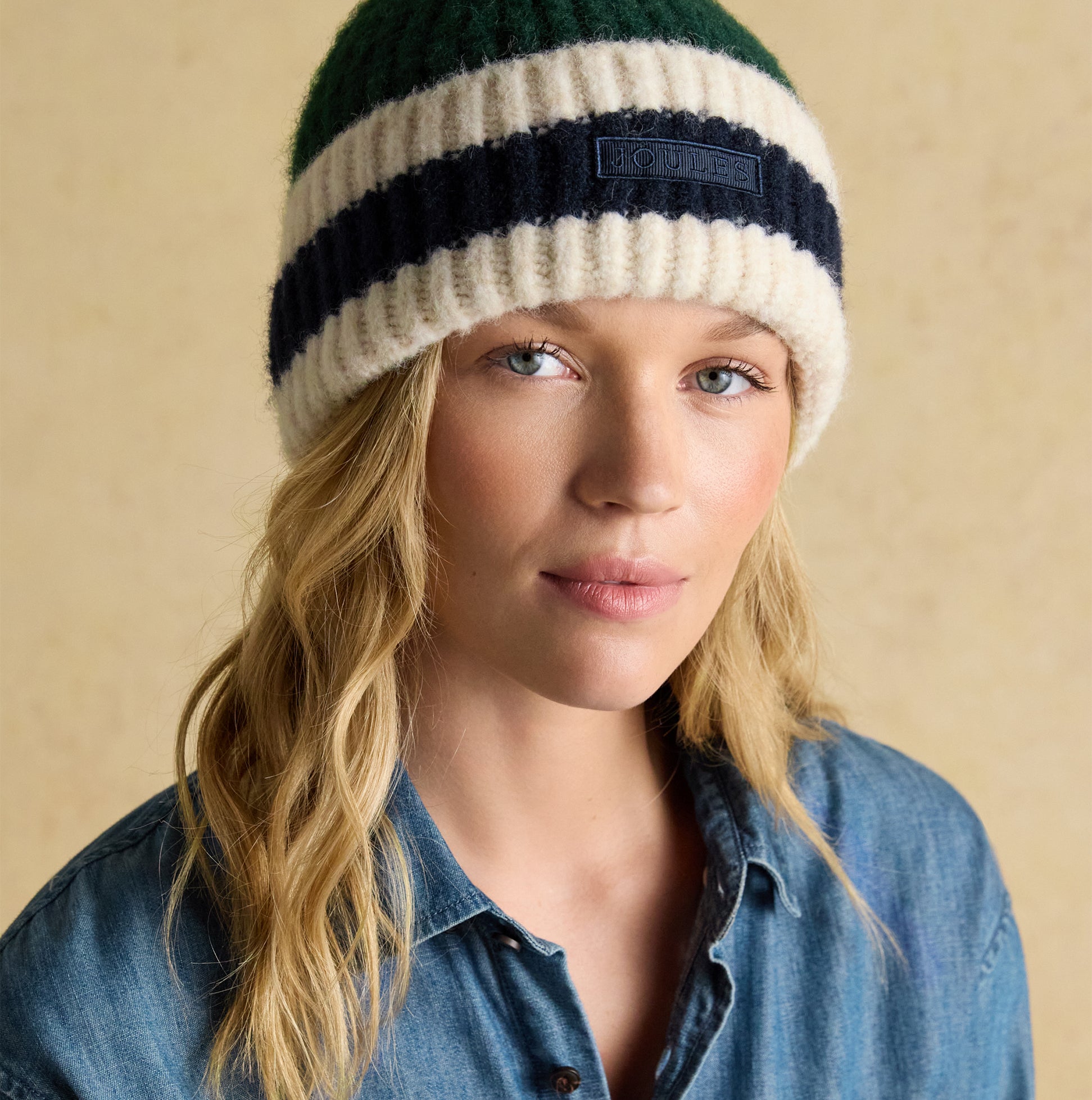 Joules POPLEY STRIPE Womens Beanie Green/Blue front view on model with casual denim shirt.