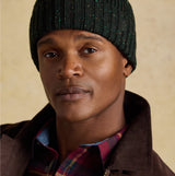 Joules HAMMOND Mens Beanie Green front view worn by model, showcasing knitted texture and style.