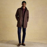 Joules HAMMOND Mens Beanie Green worn with a brown coat, standing front view on a neutral background.