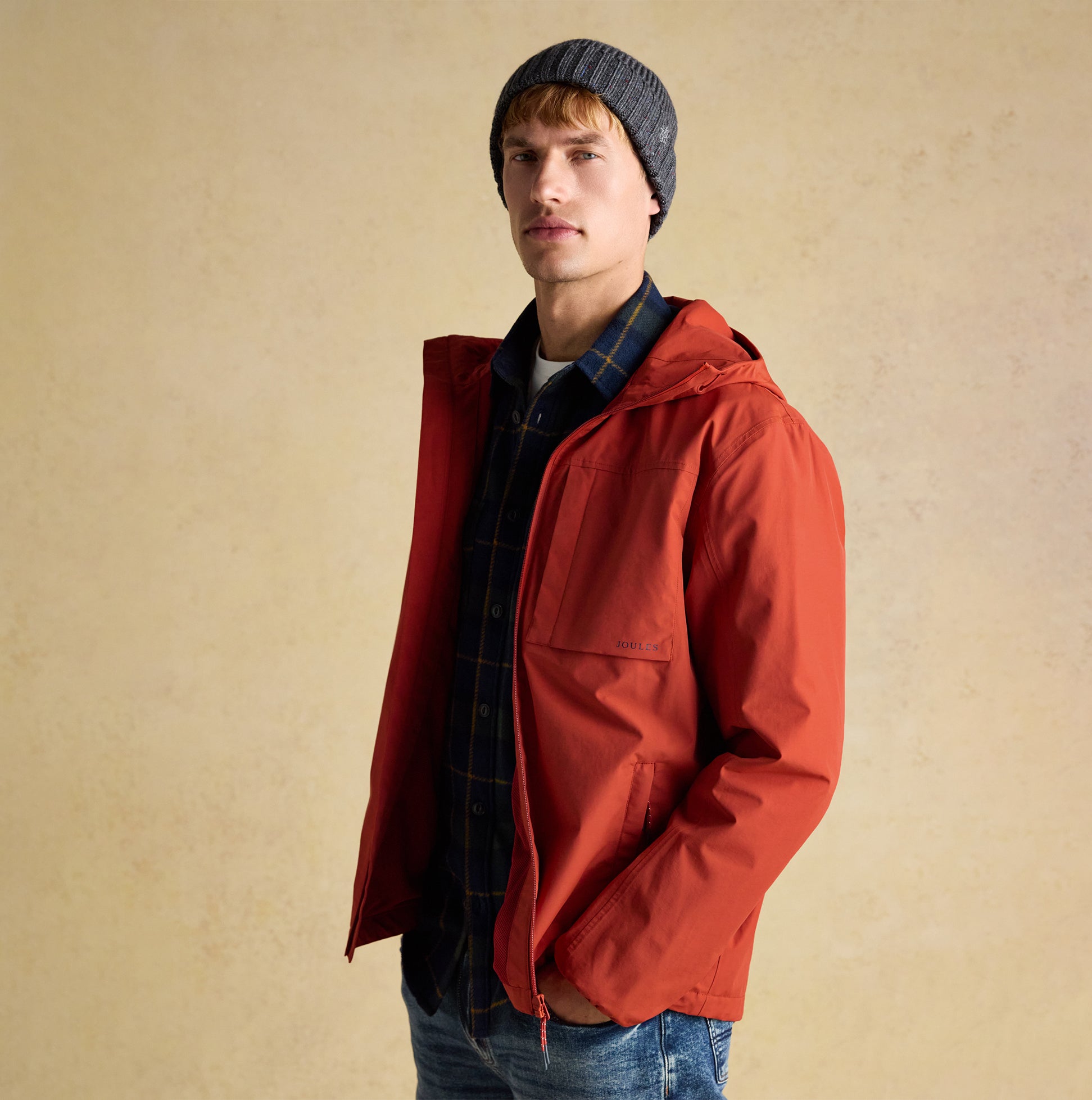 Joules HAMMOND Mens Beanie Grey worn by a model in a front view with a red jacket and plaid shirt.