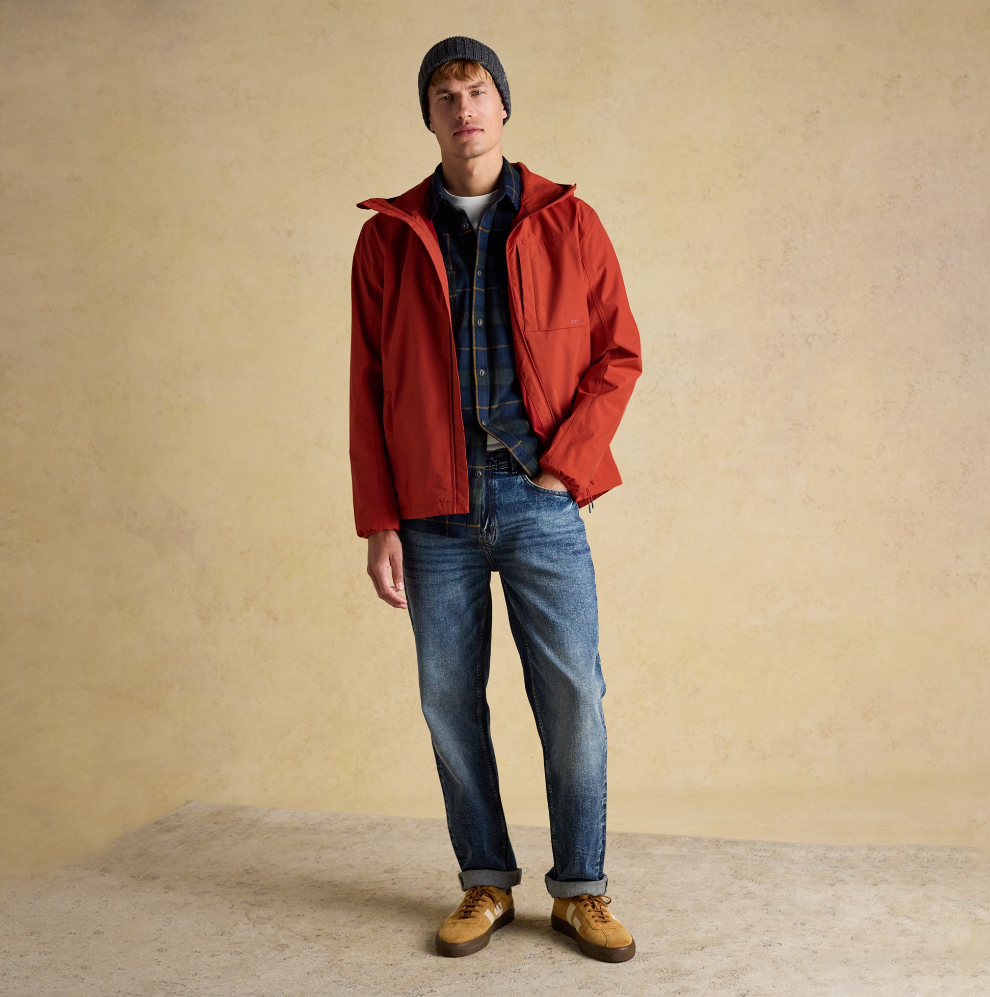 Joules HAMMOND Mens Beanie Grey worn by model in side view with red jacket and jeans.