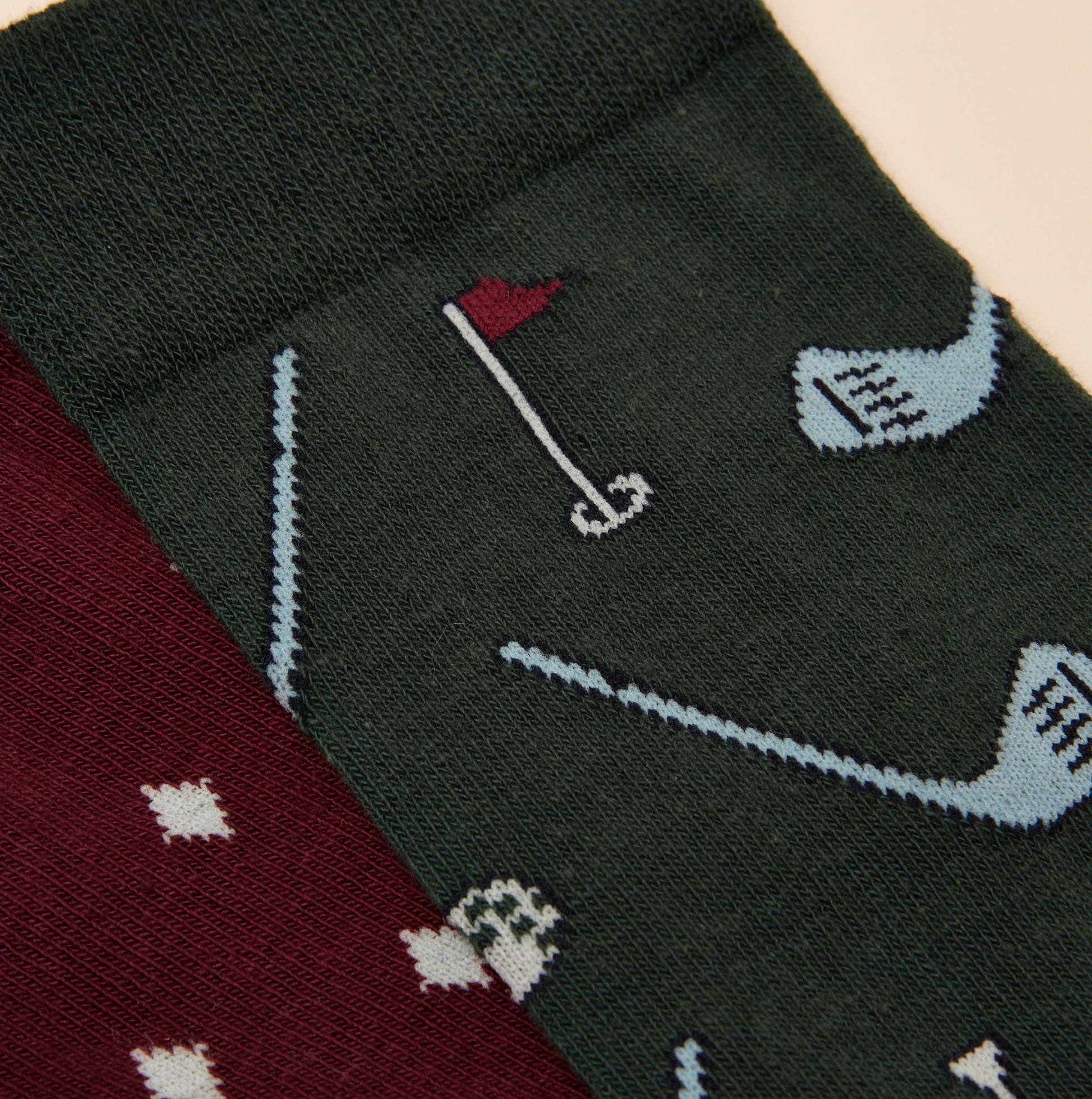 Joules KINGSBURY Mens Socks Red/Green detail view showcasing playful golf-themed patterns on the fabric.