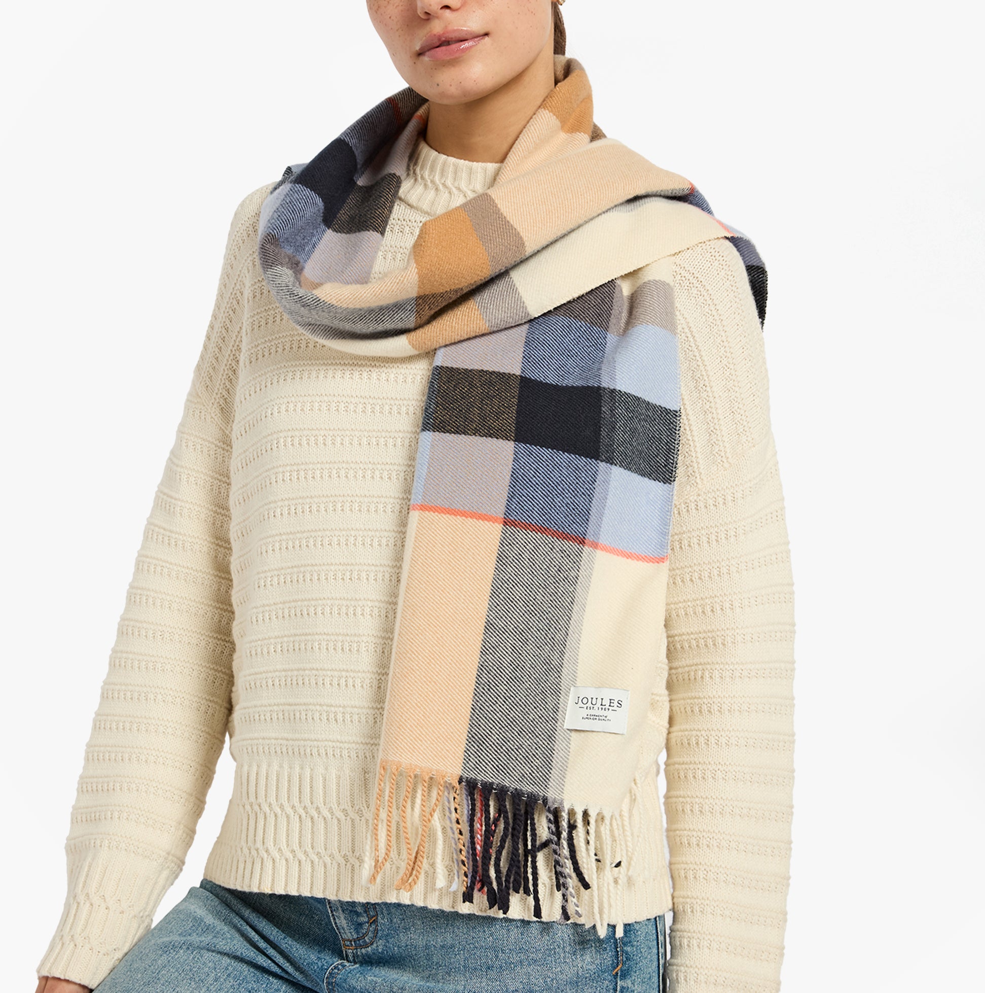 Joules LANGTREE Womens Winter Cream/Blue detail view of the scarf worn with a cream sweater, showcasing warm colors and patterns.