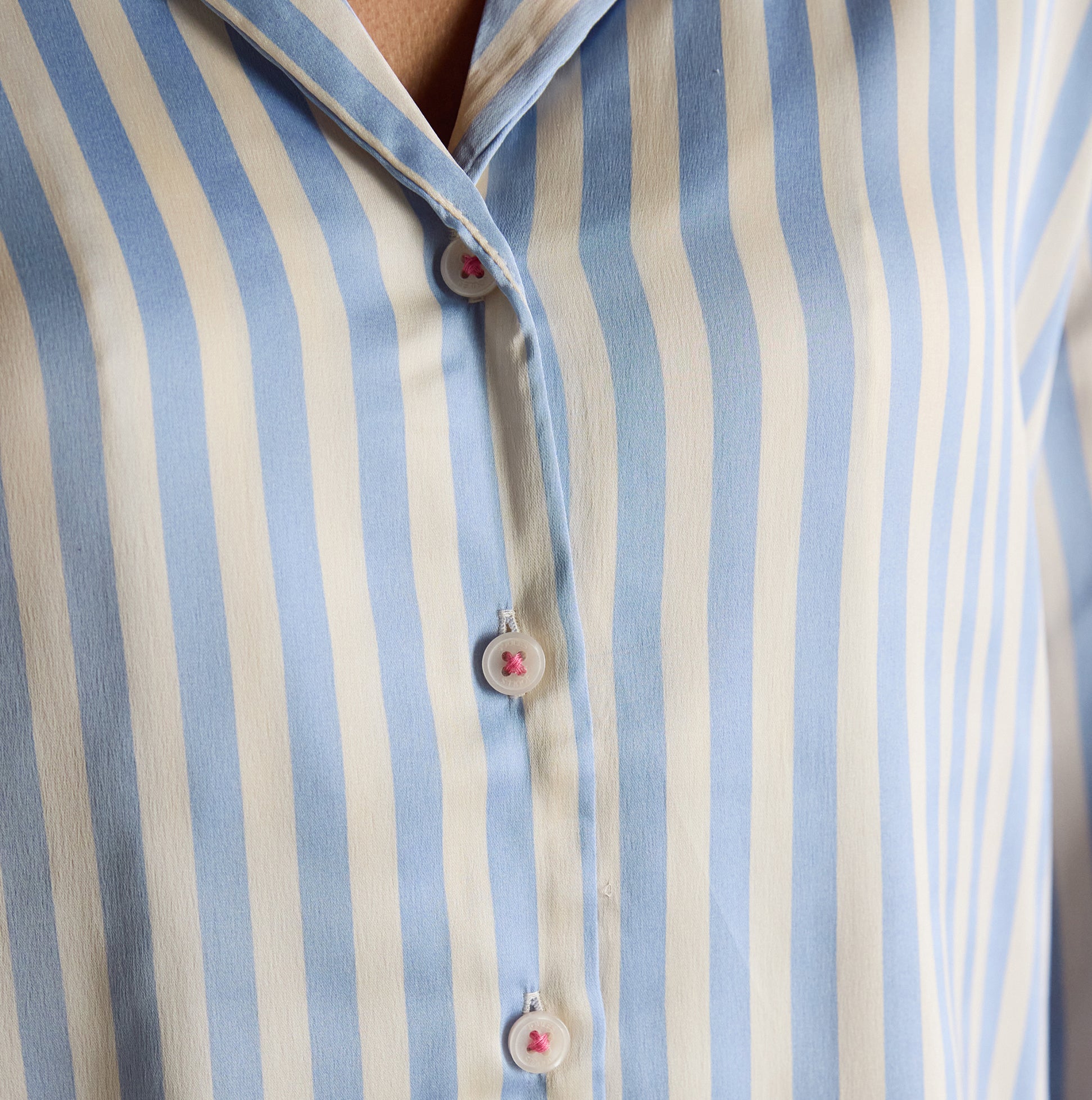Joules BONNIE Womens Satin Pyjama Set Blue Stripe detail view of blue and white striped shirt fabric and buttons.
