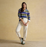 Joules LARA SLUB Womens Rugby Shirt Green front view, featuring stripes and relaxed fit, paired with cream pants.