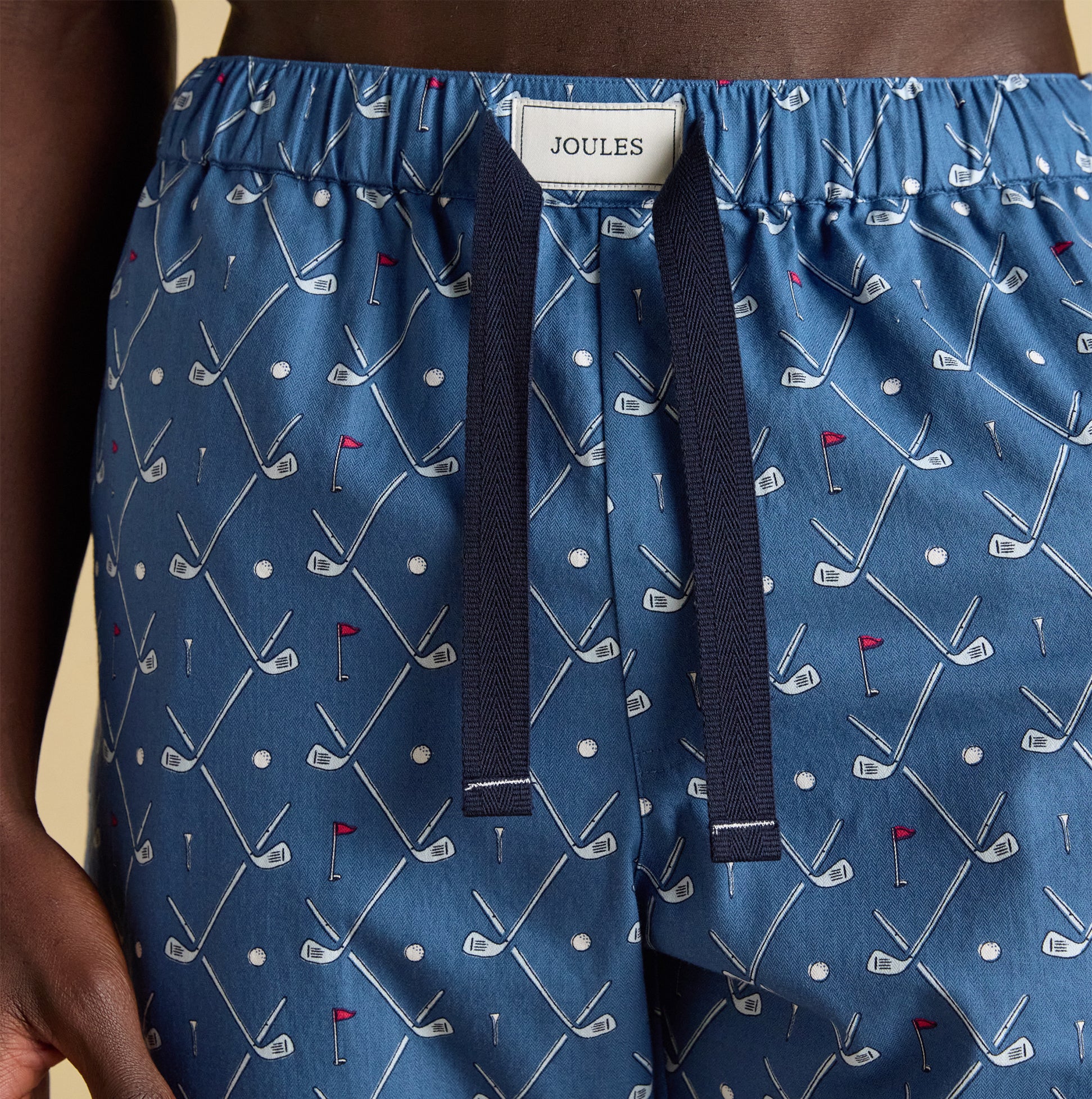 Joules DOZER Mens Pyjama Bottoms Blue detail view showcasing golf-themed pattern and relaxed fit.