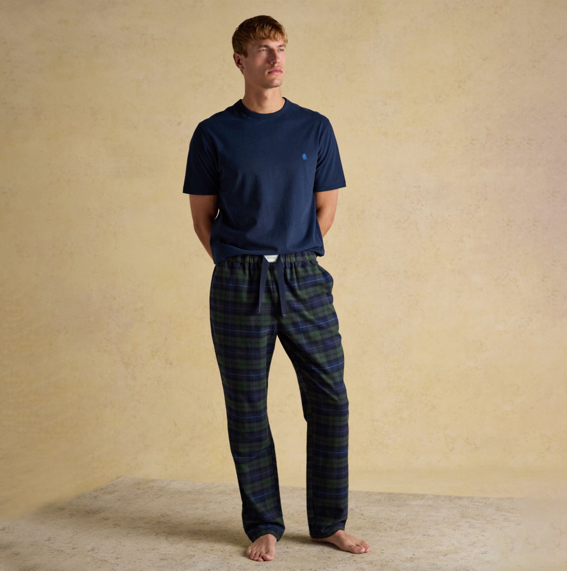 Joules DOZER Mens Pyjama Bottoms Green/Navy front view model wearing cotton relaxed fit with navy t-shirt.