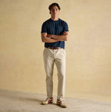 Joules RUGBY CLUB TEE Mens T-Shirt Navy front view worn by a man with cream trousers and shoes.