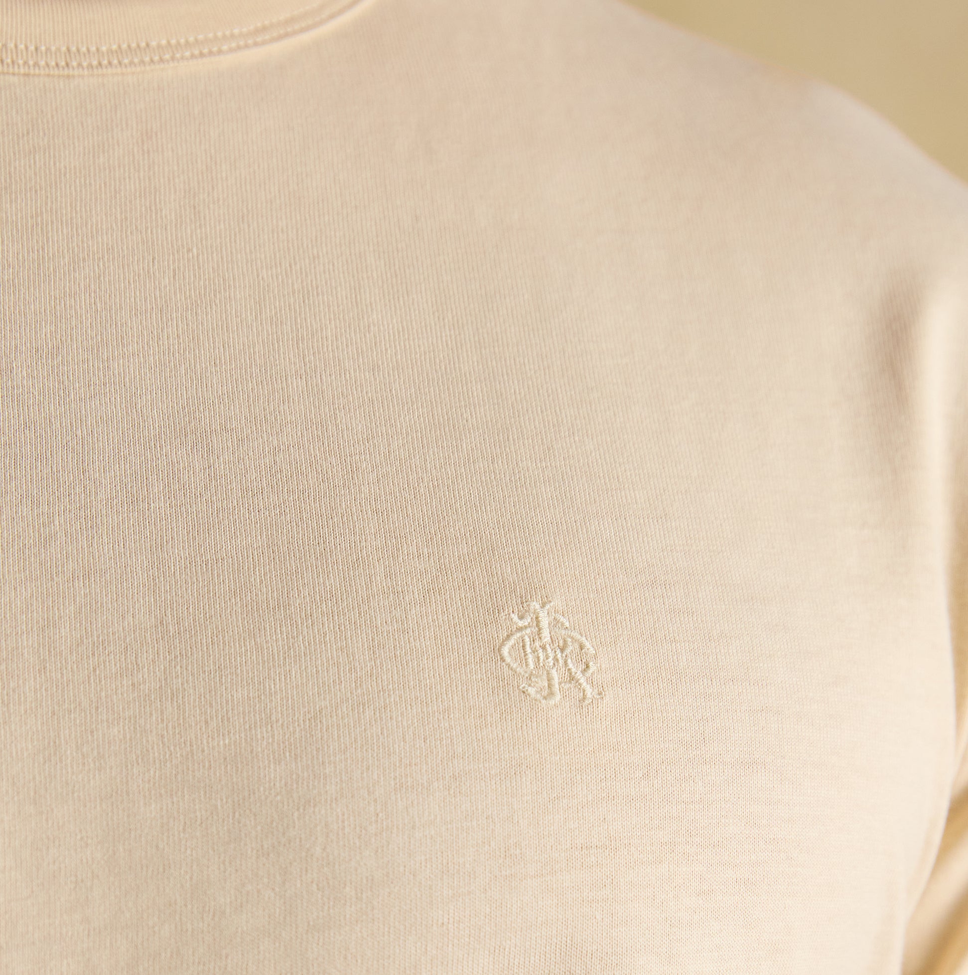 Joules RUGBY CLUB TEE Mens T-Shirt Cream detail view showcasing the embroidered logo on a cream cotton fabric.