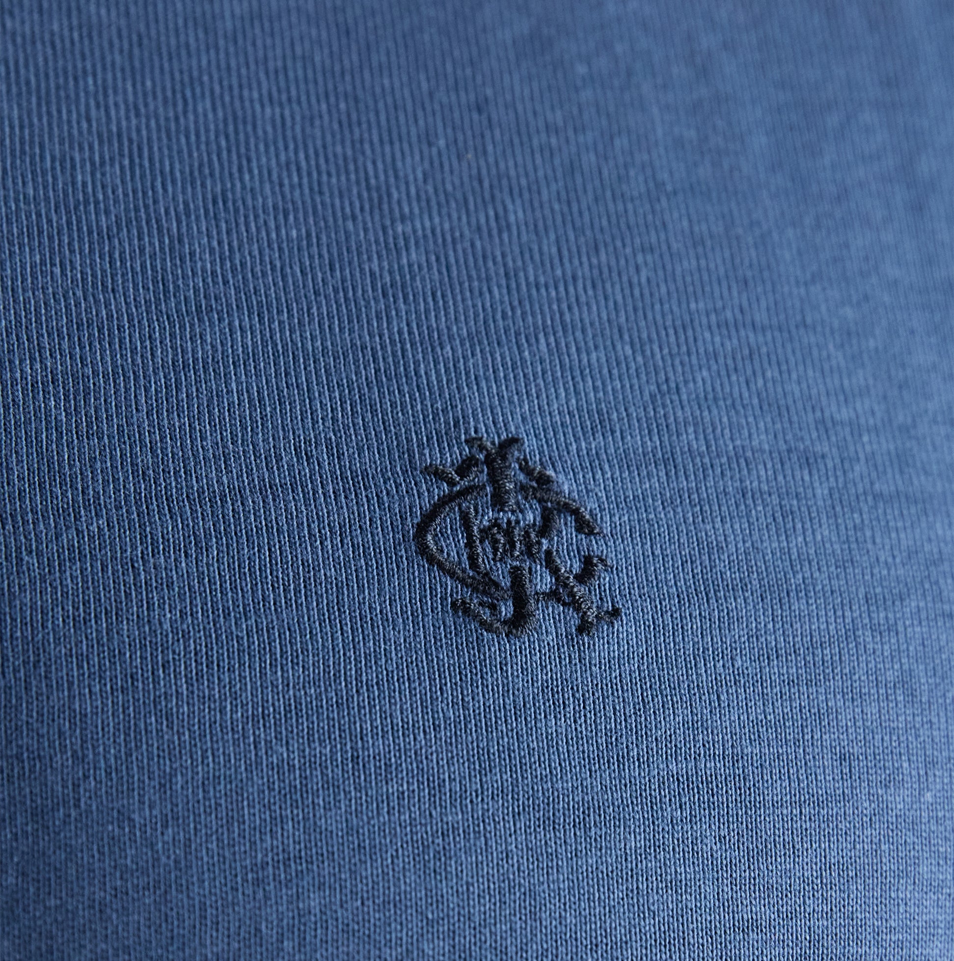 Joules RUGBY CLUB TEE Mens T-Shirt Blue detail view of logo embroidery on fabric.