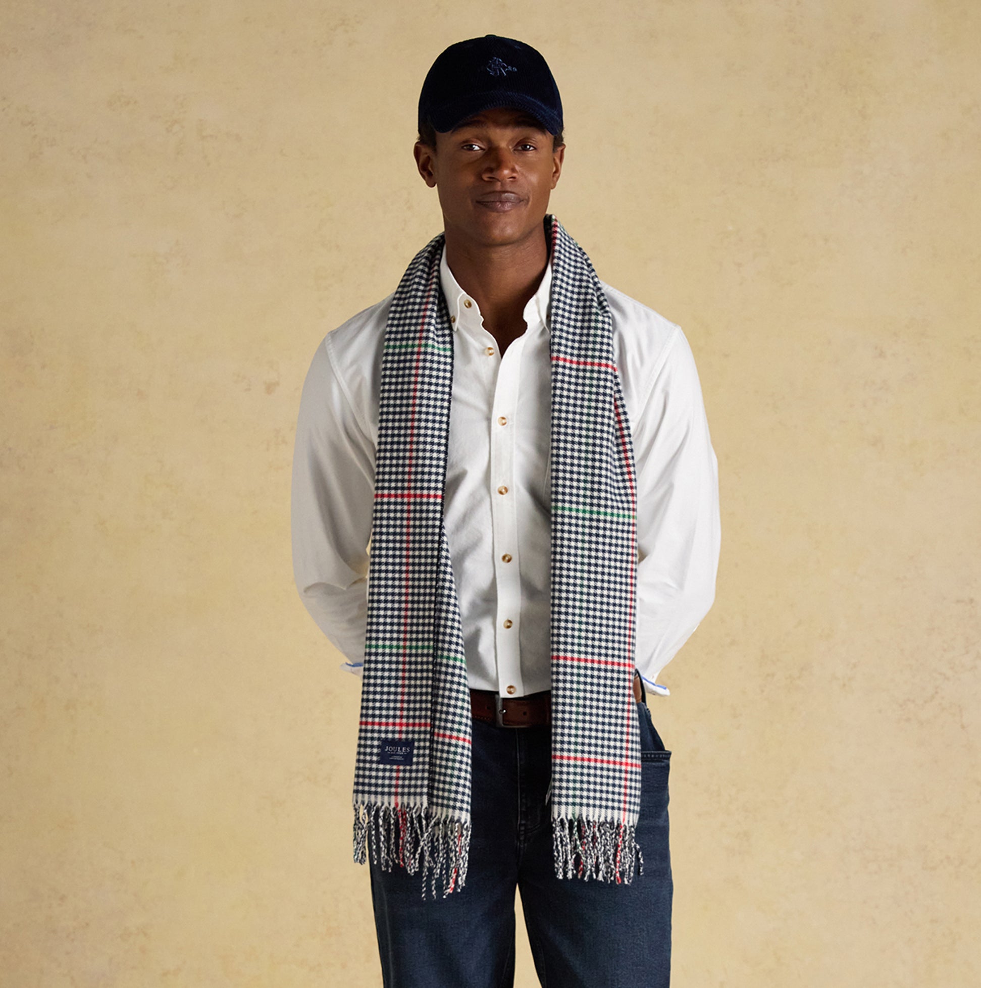 Joules LANGTREE Mens Winter Cream/Navy front view, model wearing scarf with fringes, stylish winter accessory.