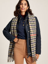 Joules LANGTREE Womens Scarf Henson Check, detail view draped over a navy quilted jacket on a model.