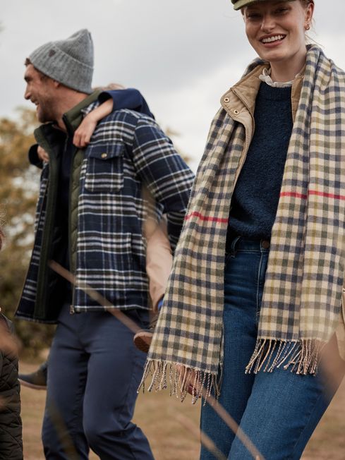 Joules LANGTREE Womens Scarf Henson Check worn by a woman in a front view, featuring a heritage check pattern and tasselled ends.