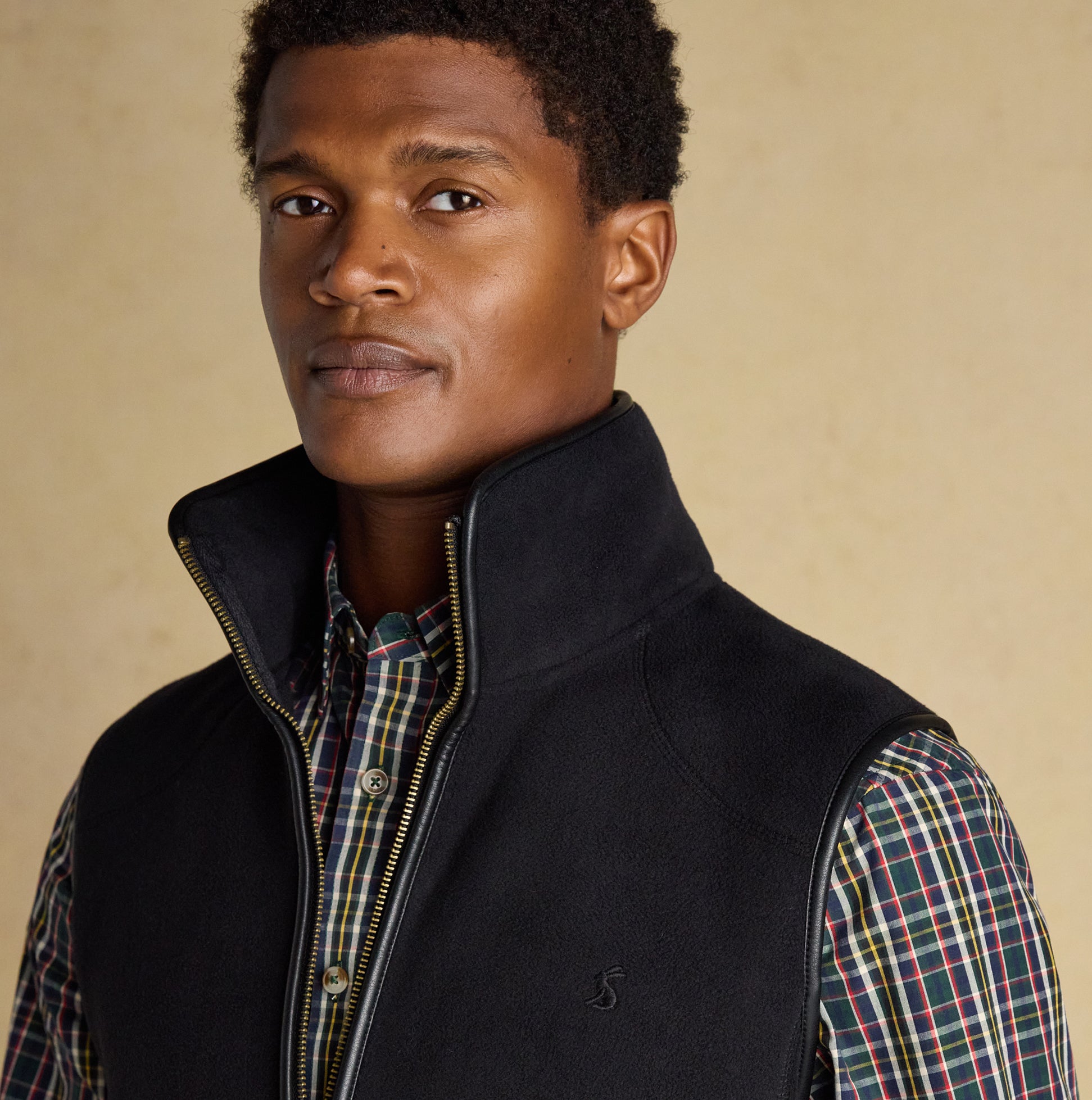 Joules HERITAGE FLEECE Mens Gilet Black front view featuring a model wearing a sleeveless black fleece gilet.
