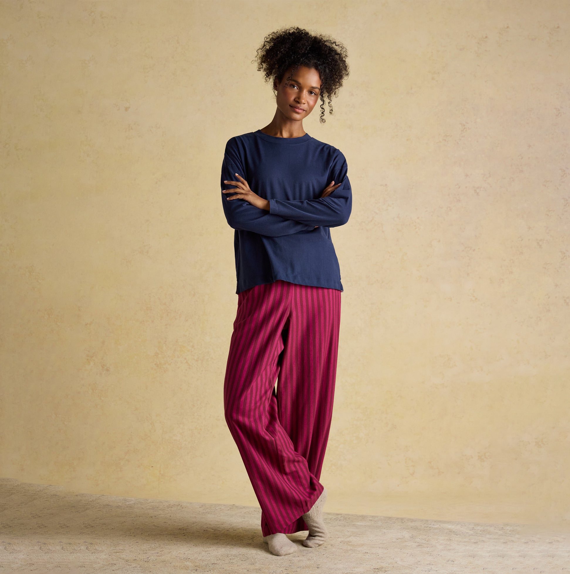 Joules JERSEY Pyjama Top Womens Sweatshirts Navy front view, paired with pink striped pants, model standing.