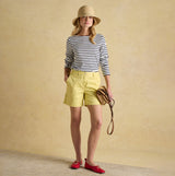 Joules HARBOUR Boat Neck 100% Cotton Breton Top Cream/Navy Stripe front view with yellow shorts and red shoes.
